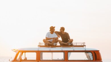 happy friends on camper van roof