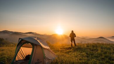 silhouette of person standing near camping tent