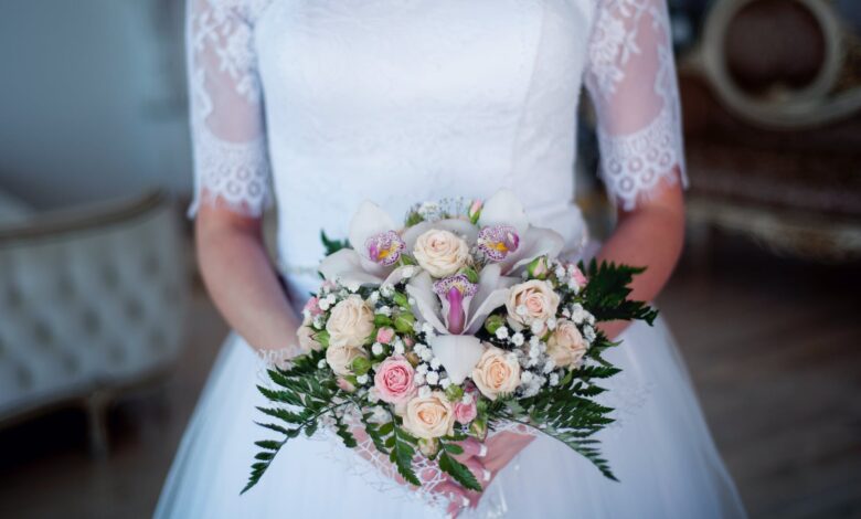 woman wearing wedding gown holding bouquet