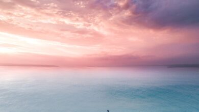 seascape of a turquoise water under a pink sunset sky