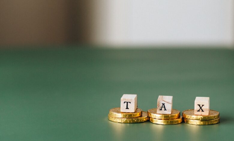 tax word on top of gold coins